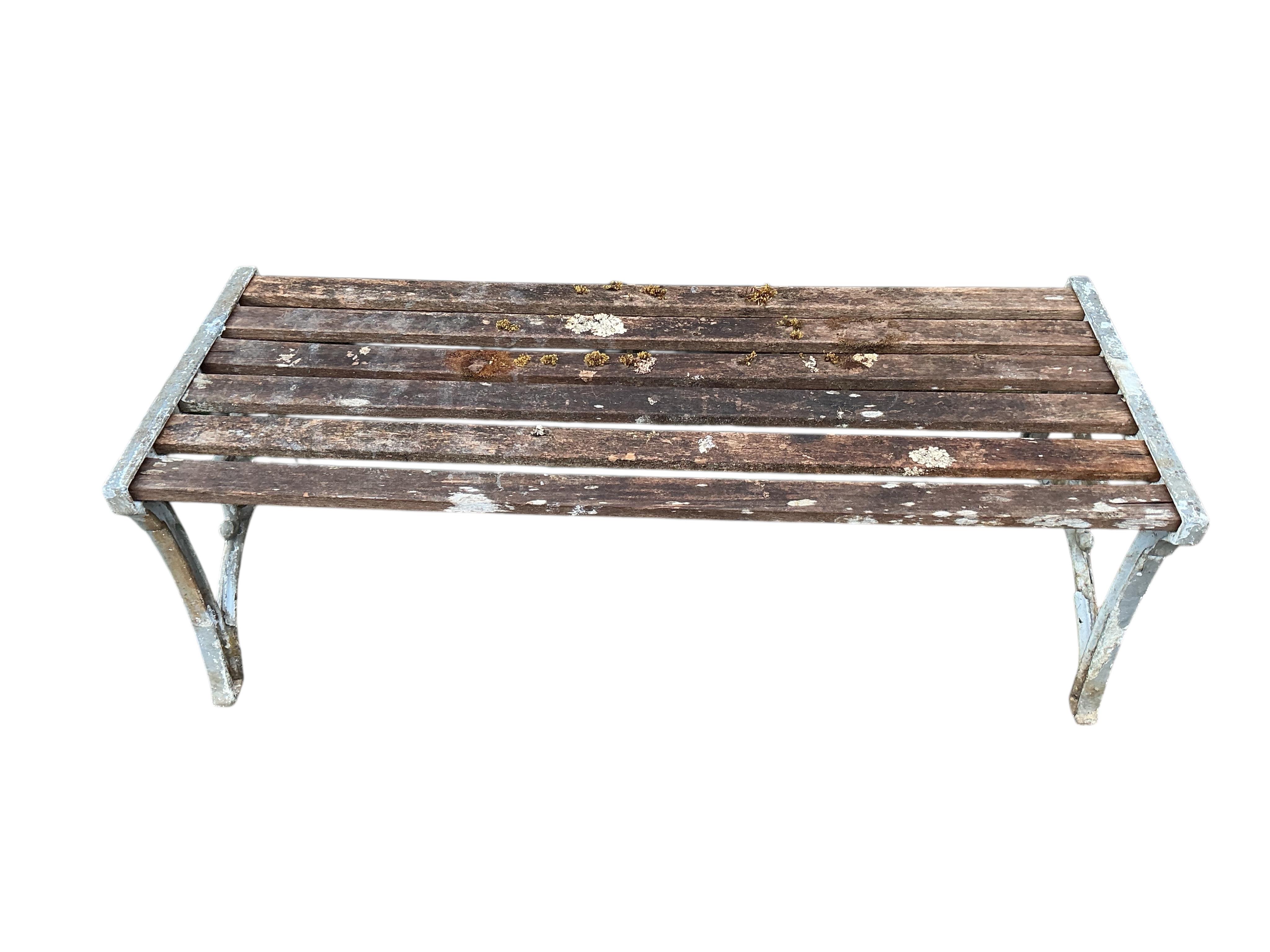 A pair of Victorian style cast metal bench ends and a slatted wood garden bench